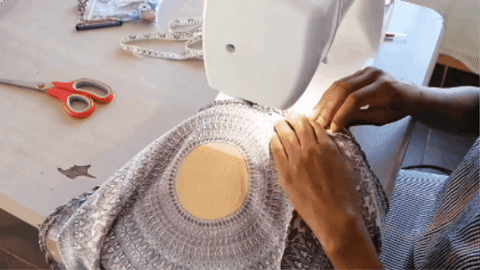 A fashion designer sewing a circle skirt
