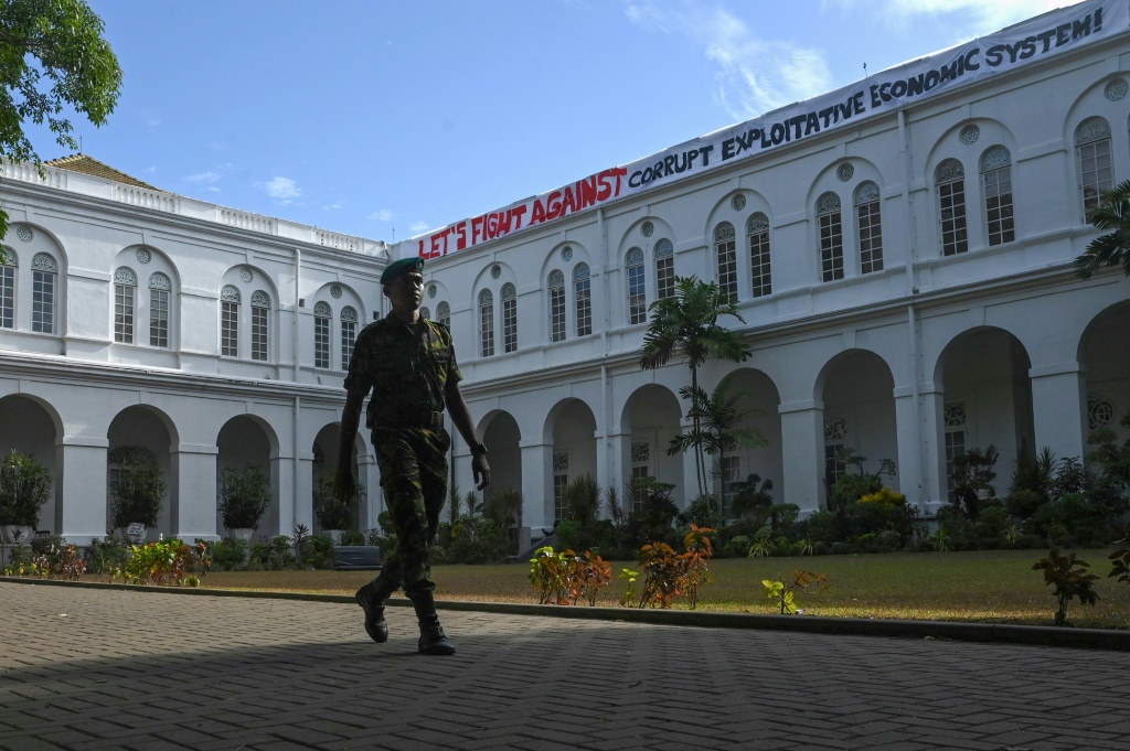 A cadet walks in front of the Sri Lankan president’s official residence on Friday after it was overrun by protesters last weekend