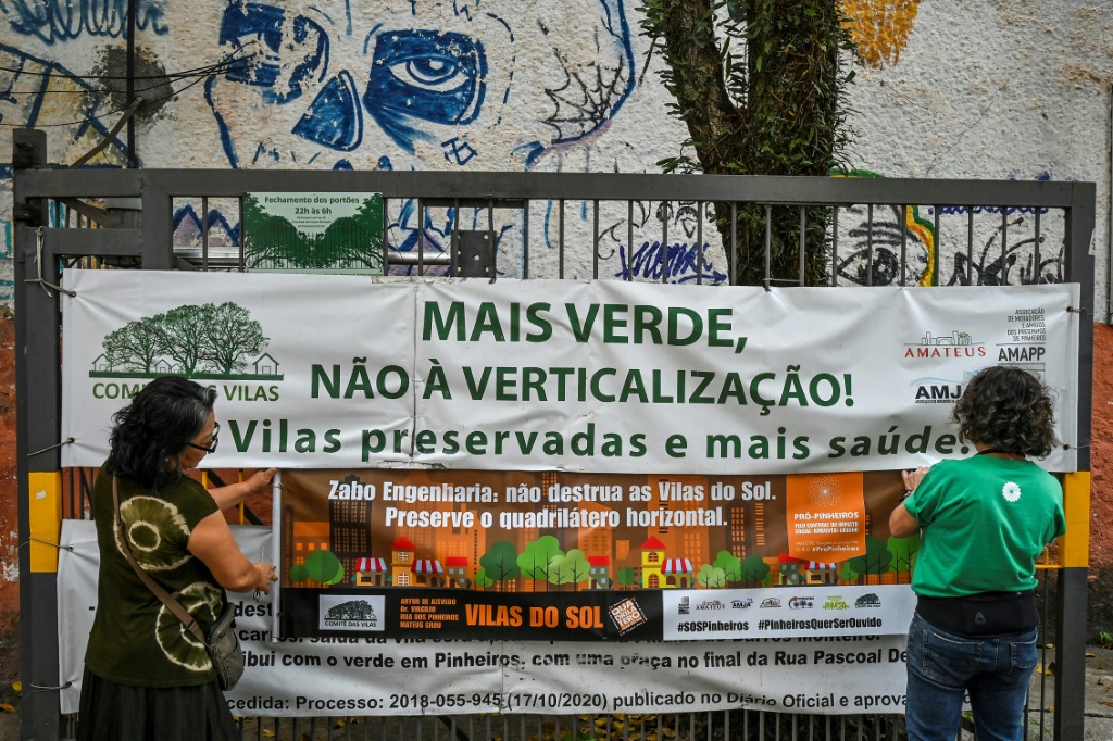 Activists from the Pro Pinheiros association place a banner on a gate that reads "More green, not verticalization" in the Pinheiros neighborhood, Sao Paulo, Brazil, on September 5, 2023
