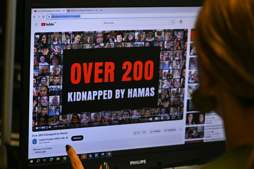 This photograph taken on October 26, 2023, shows a woman looking at a computer screen in Paris, displaying an advertisement on the YouTube platform for a campaign financed by The Israeli Ministry of Foreign Affairs. Thousands of civilians, both Palestinians and Israelis, have died since October 7, 2023, after Palestinian Hamas militants based in the Gaza Strip entered southern Israel in an unprecedented attack triggering a war declared by Israel on Hamas with retaliatory bombings on Gaza.
