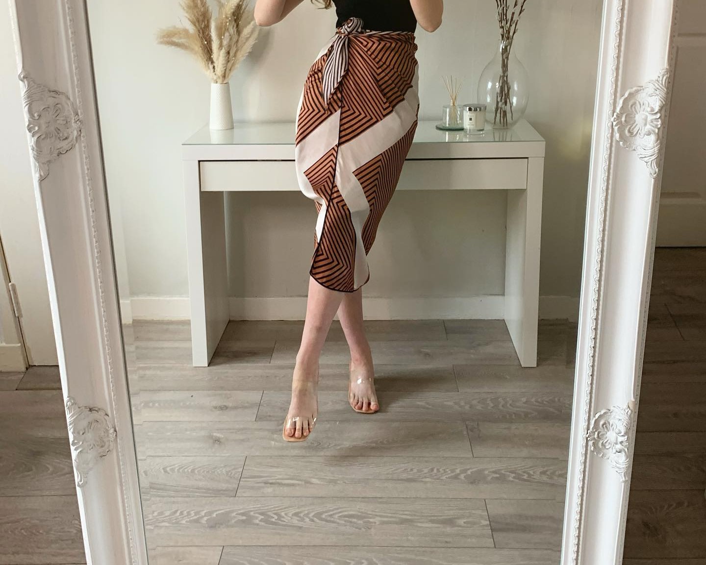 A woman is dressed in a gorgeous wrap skirt