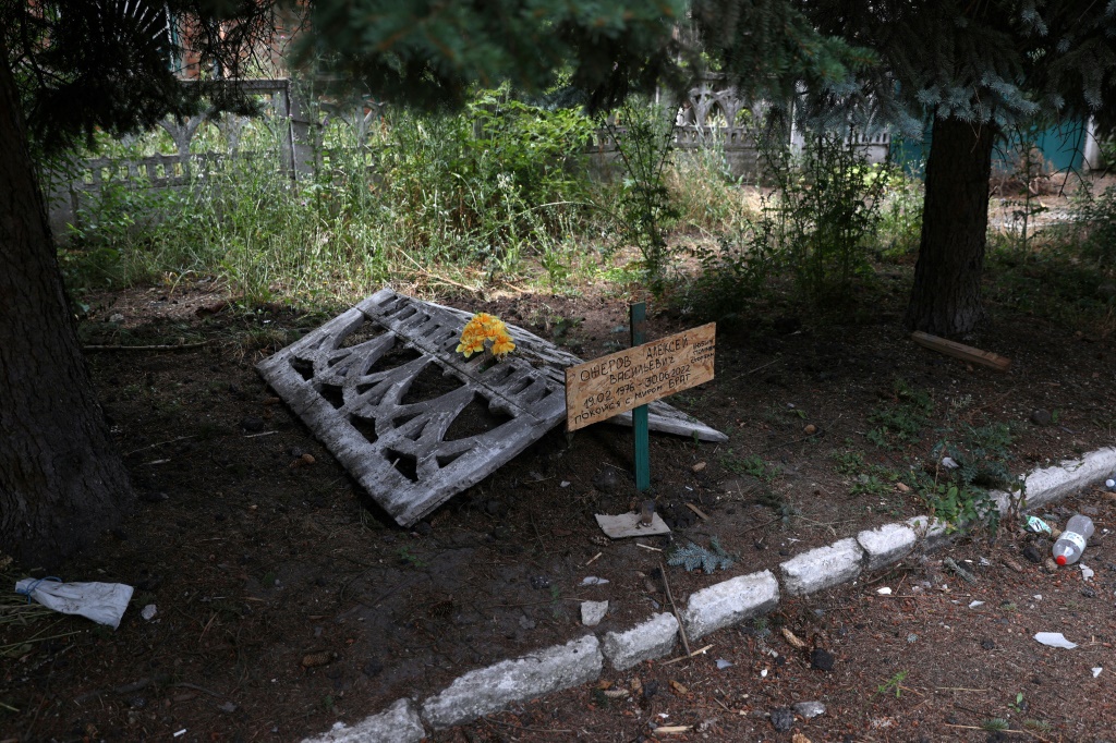 Oleksy's grave was dug hastily, on the sidewalk near one of the few buildings still standing in Siversk