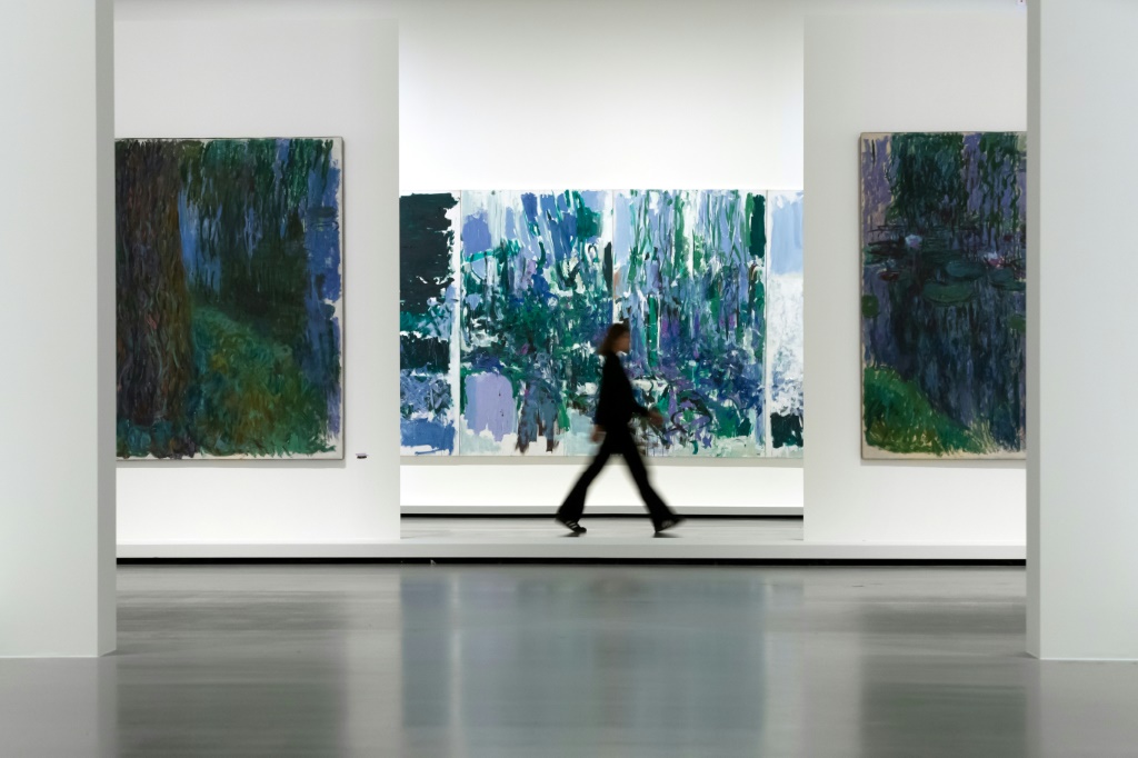 Claude Monet's (L and R) and American artist Joan Mitchell's paintings (C) at the "Monet - Mitchell" exhibition at the Fondation Louis Vuitton in Paris