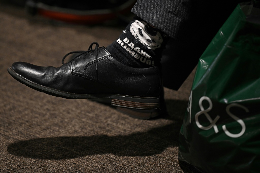 A delegate's socks carry the message 'Baahh Humbug!" -- a reference to Charles Dickens' character Ebenezer Scrooge -- as Conservative conference-goers make their feelings known