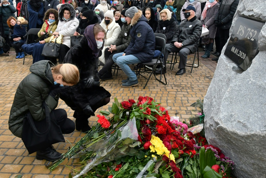 Women in Kyiv lay flowers to commemorate the crew and passengers of Ukraine International Airlines Flight 752, which was shot down by Iran