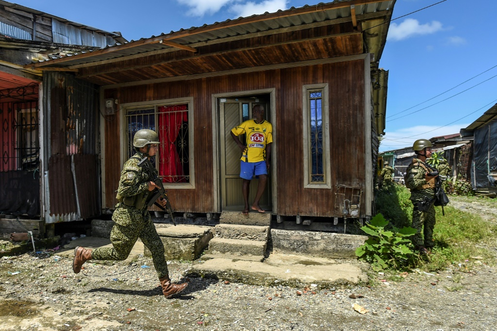 Colombia's army is making a show of force in poor Buenaventura neighborhoods faced with an escalating turf war between drug gangs