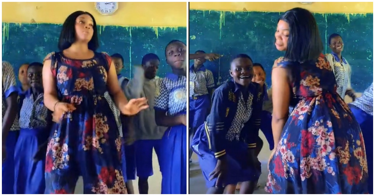 Pretty teacher doing a formation dance with her students in class