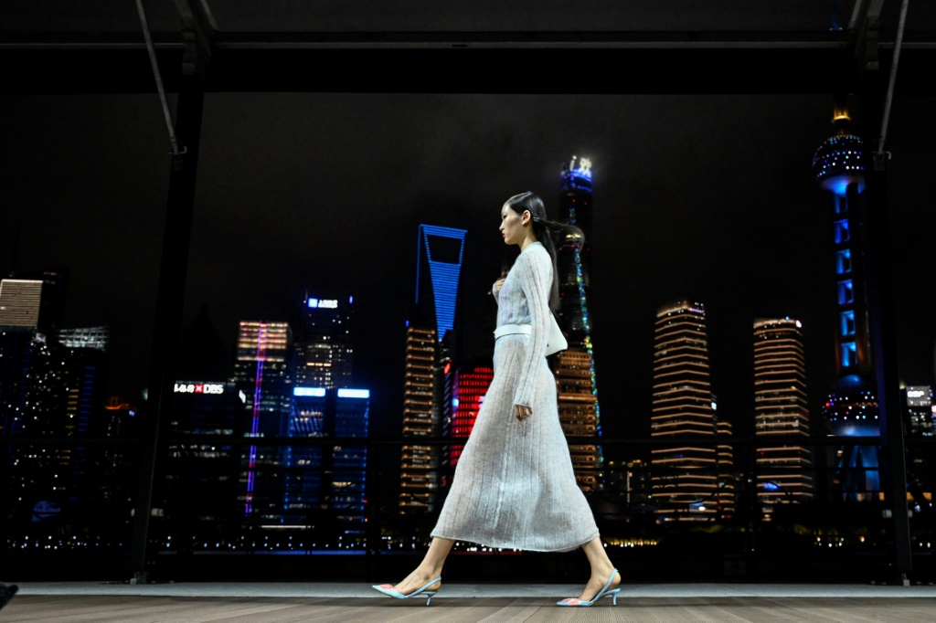 Against Shanghai's glittering river skyline, Kenzo-clad models strutted down a breezy open-air runway for the French fashion brand's first-ever show in China