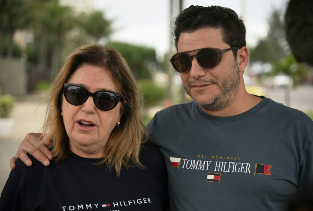 Visiting Rio, retired lawyer Mirian Rebelo and her son Rodrigo stopped to take pictures outside Jair Bolsonaro's former home