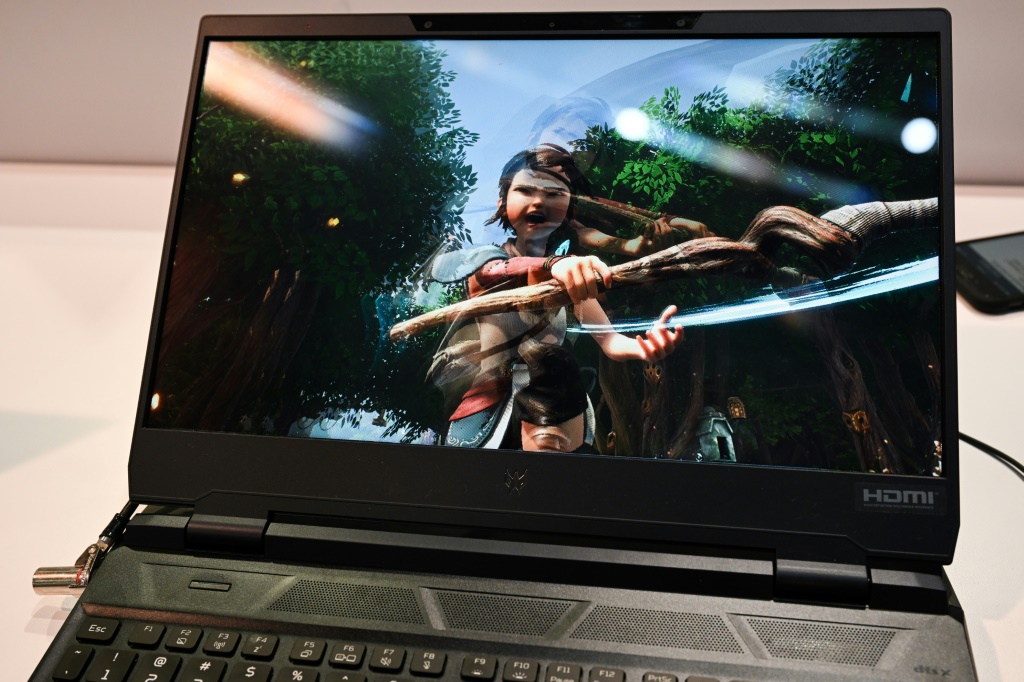 An Acer Predator Helios 300 laptop with eye tracking for glasses-free 3D video gaming is displayed at the CES Microsoft booth