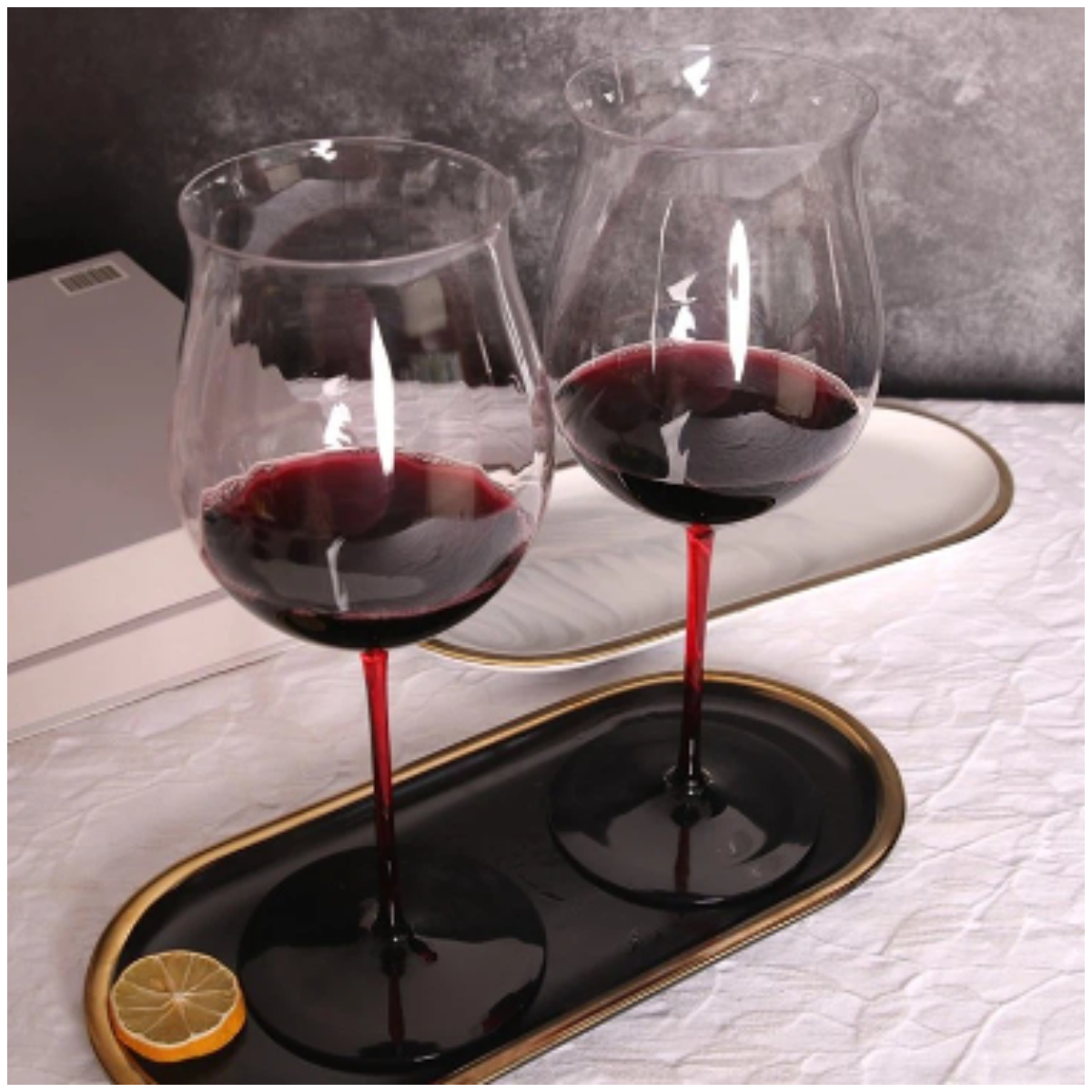 Two burgundy glasses on a serving tray