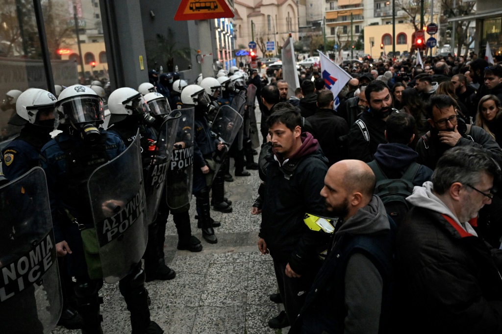 Riot police form a security cordon in front of the Hellenic Train headquarters in Athens, during a protest, following the deadly accident near the city of Larissa