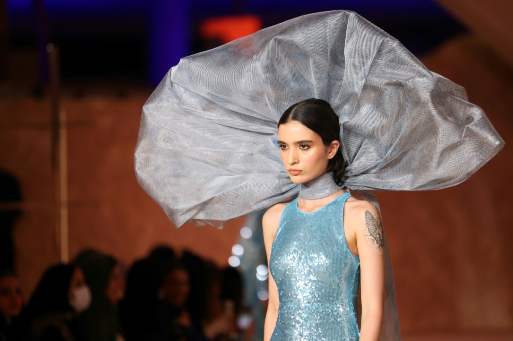 A model walks the catwalk at this year's Riyadh Fashion Week, a milestone in a country that used to require women to wear hijab headscarves and abaya robes in public