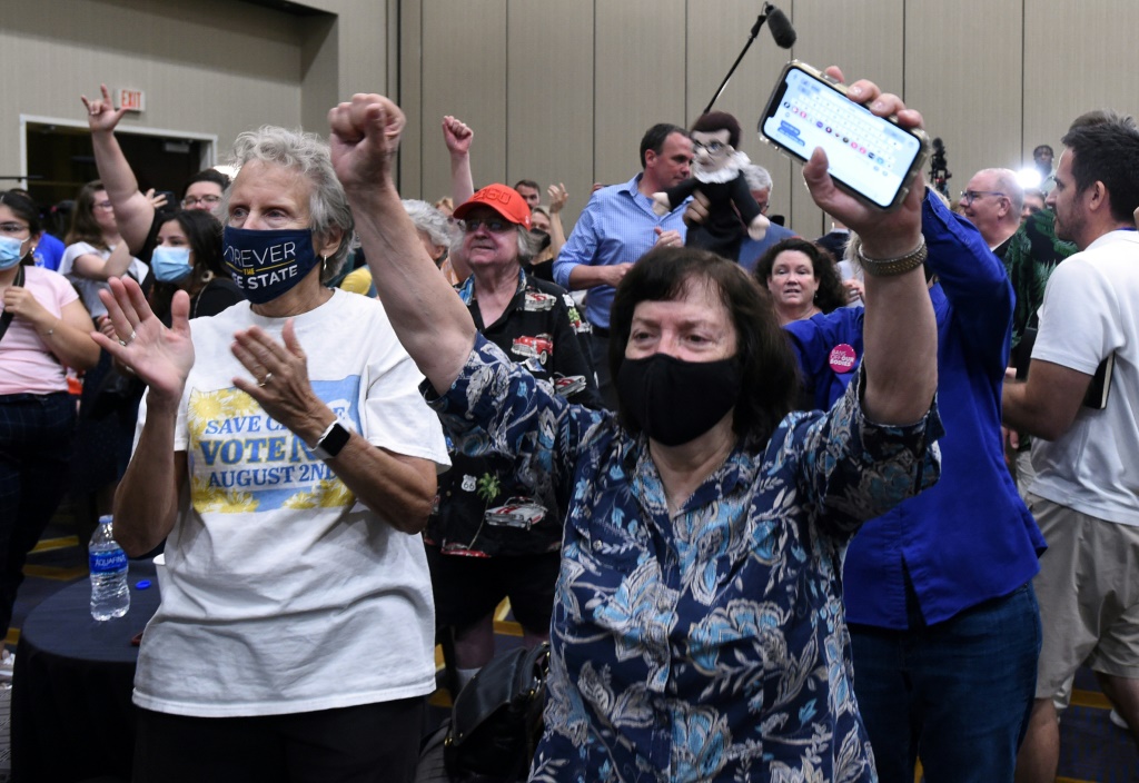 Pro-abortion rights supporters cheer as voting results show Kansas has voted to maintain the statewide right to abortion, in Overland Park, Kansas