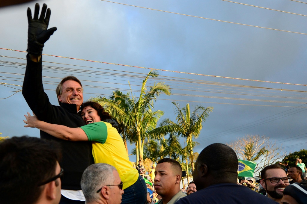 Brazilian president Jair Bolsonaro waves at supporters during a motorcade in Joinville, Brazil on October 1, 2022, on the eve of the presidential election