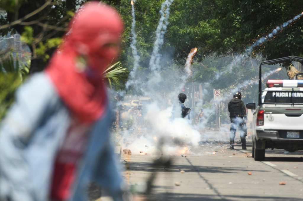 Police fire tear gas canisters at protesters in the streets of Santa Cruz, Bolivia, on November 11, 2022