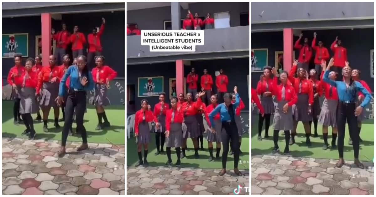 Pretty female teacher in trousers dances with her intelligent students in school, Video warms hearts