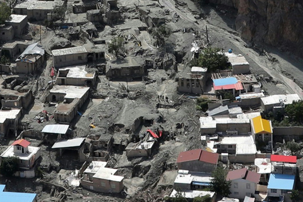 Houses surrounded by mud deposits at the site of a flash flood east of Tehran in the Firouzkouh area, where a landslide killed 14 people