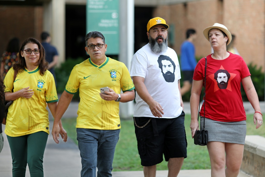 Brazilian nationals wearing pro-Lula T-shirts and Bolsonaro's favored yellow and green cast absentee ballots in Orlando, Florida