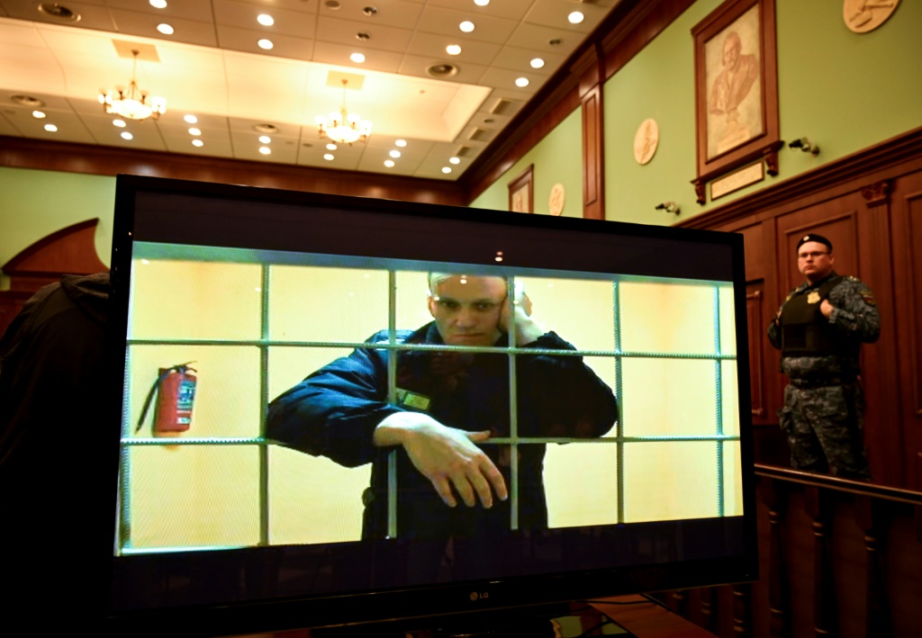 Alexei Navalny appears on a screen at a Moscow courtroom via a video link from his prison colony