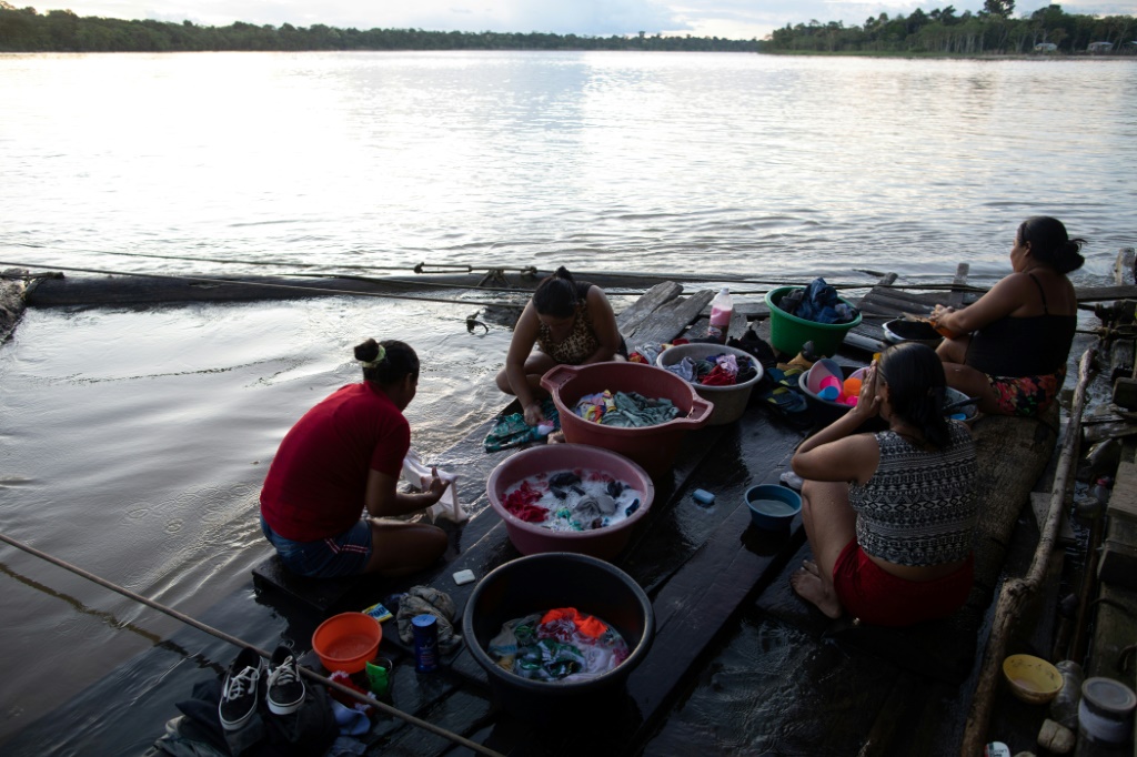 Women wash clothes on the banks of the Javari river in Atalaia do Norte, a town beset with crime