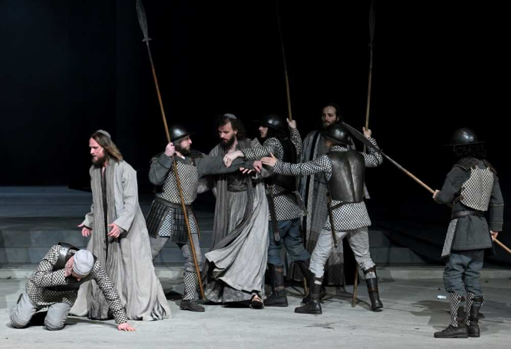 The play's themes of violence, poverty and sickness are reflected in today's world through the war in Ukraine and Covid, says Frederik Mayet (2ndL) who plays Jesus