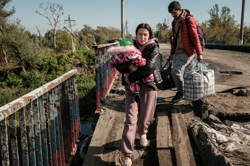 Civilians needed to cross a heavily damaged bridge across the Oskil River in Kupiansk on foot to move away from the front lines