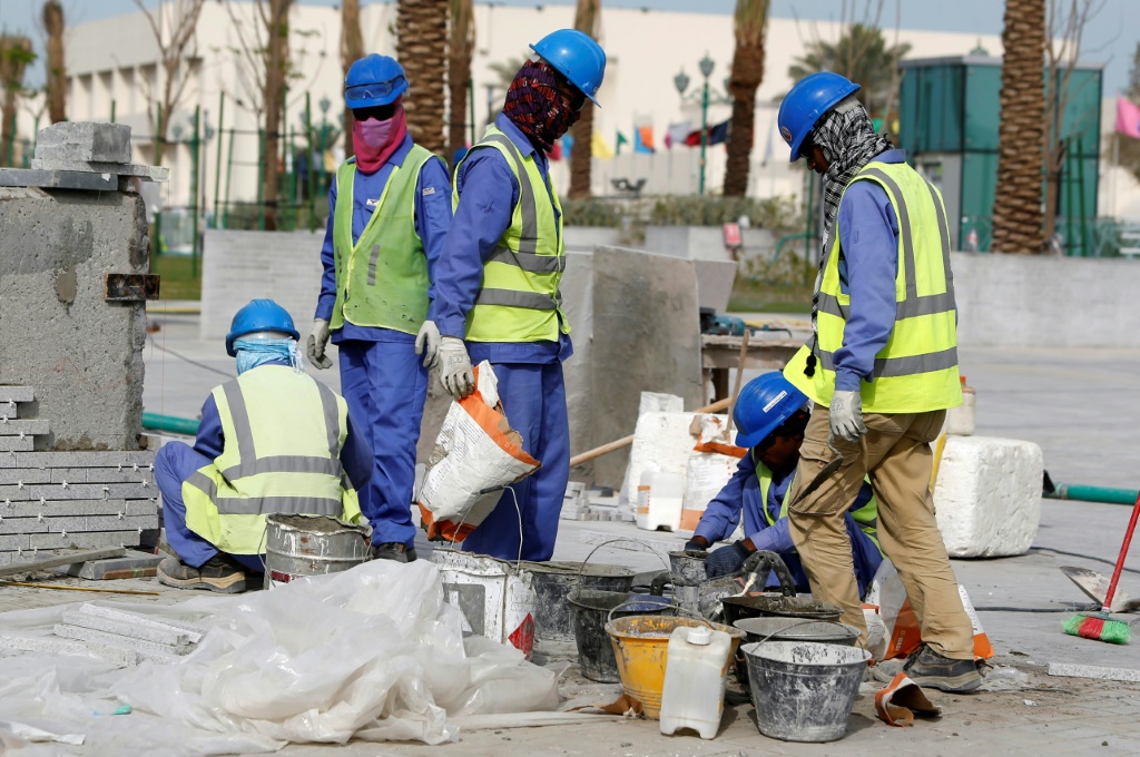 Workers of Vinci's Qatar subsidiary QDVC preparing cement in Doha in 2015