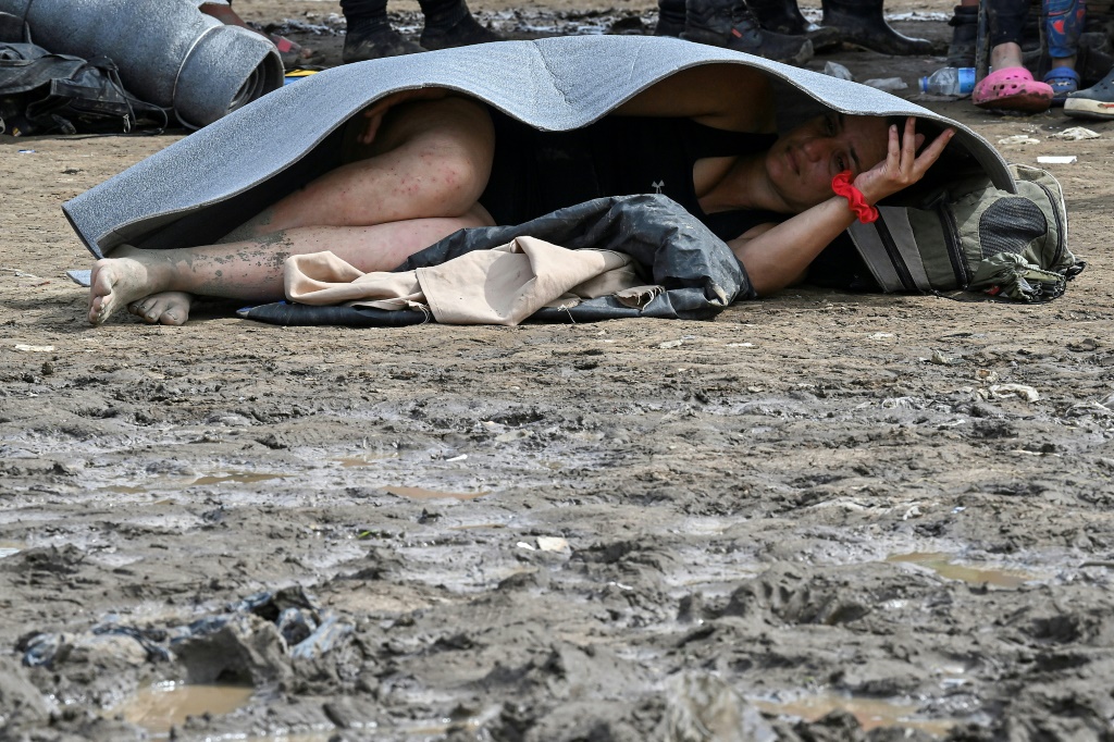 A Venezuelan migrant rests on the ground in Canaan Membrillo village