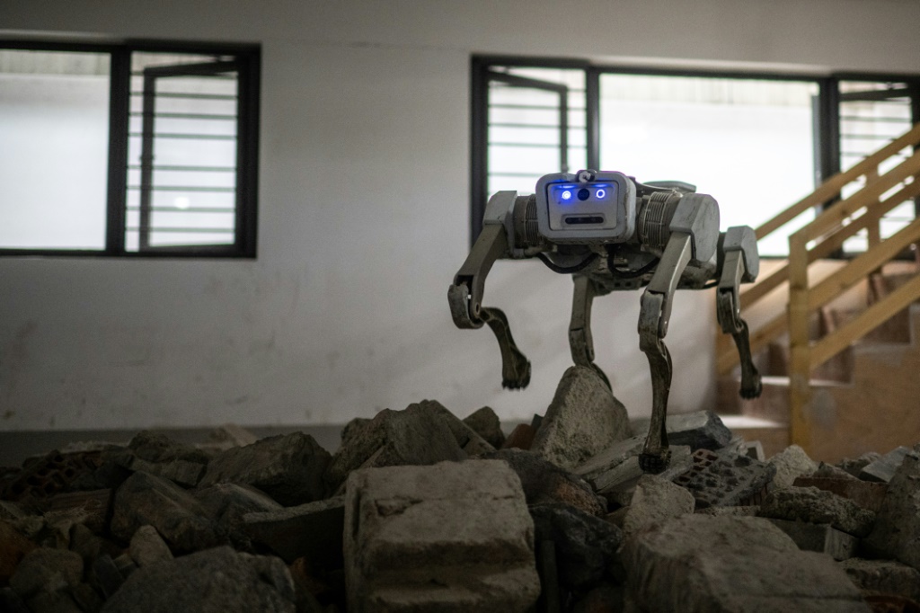 A robot dog tramples over rubble in a demonstration