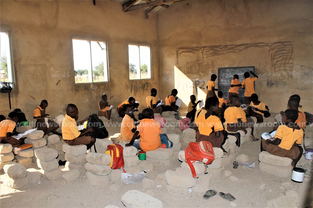 Pupils of Abolato primary use cement blocks to study