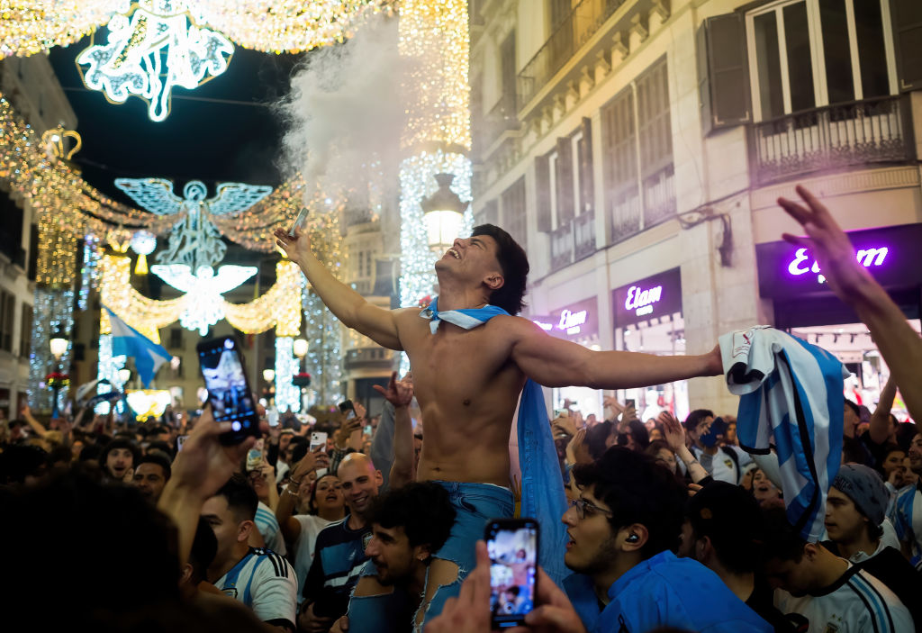 A shirtless Argentinian fan is seen celebrating Argentina's victory after the FIFA 2022 World Cup final match.