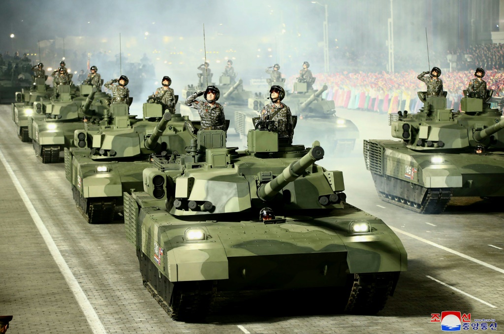 In this photo taken on April 25, 2022 this picture released from North Korea's official Korean Central News Agency (KCNA) on April 26 shows troops saluting on tanks during a military parade to celebrate the 90th anniversary of the founding of the Korean People's Revolutionary Army at Kim Il Sung Square in Pyongyang
