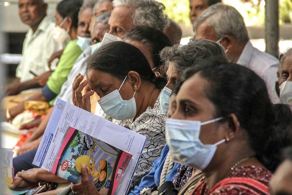 Patients wait for their appointment with medical staff outside the out-patient department at the National Hospital in Colombo