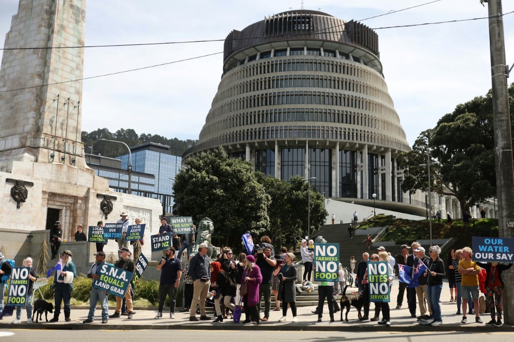 Protestors against the government's plans to tax emissions from farm animals gather outside New Zealand's parliament in Wellington on Thursday