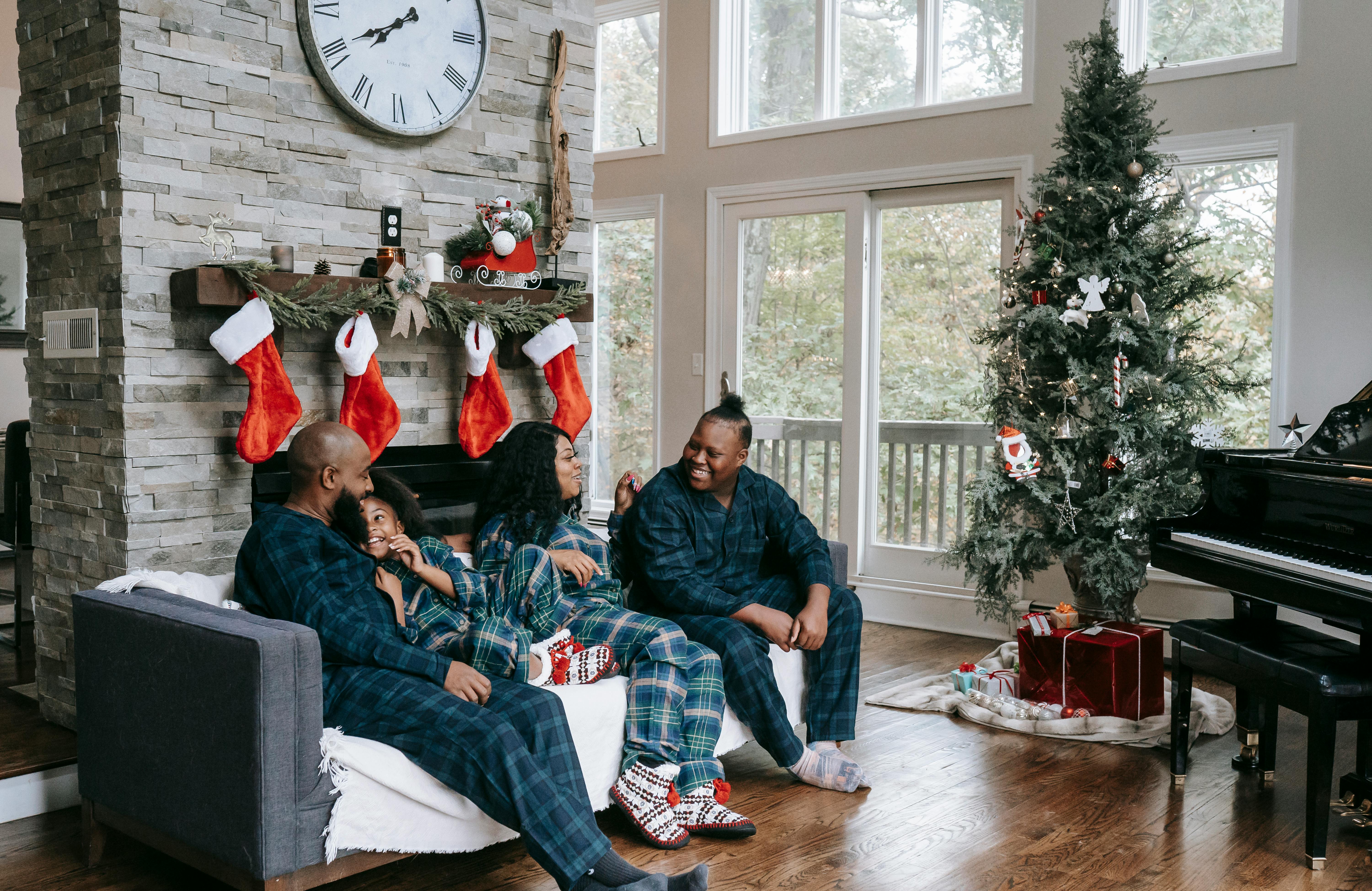 A family seated on the sofa during Christmas