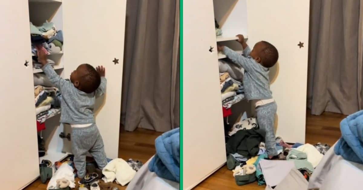Child unpacking clothes from the wardrobe