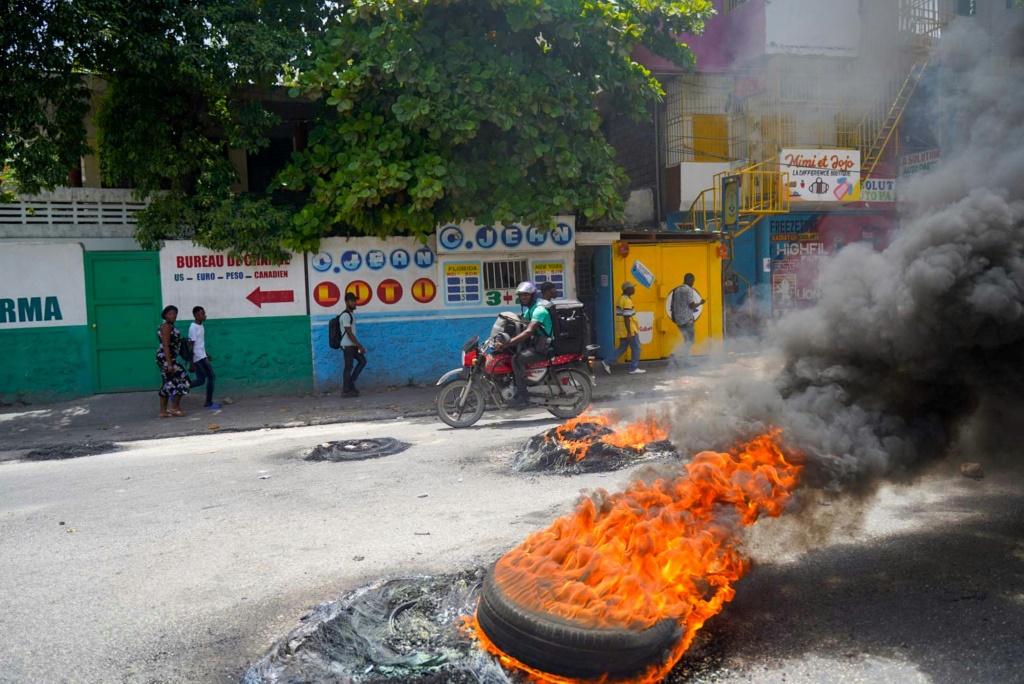 Haitians protesting in Port-au-Prince in July 2022 -- soaring prices, food and fuel shortages and rampant gang violence are accelerating a brutal downward spiral for security in the capital