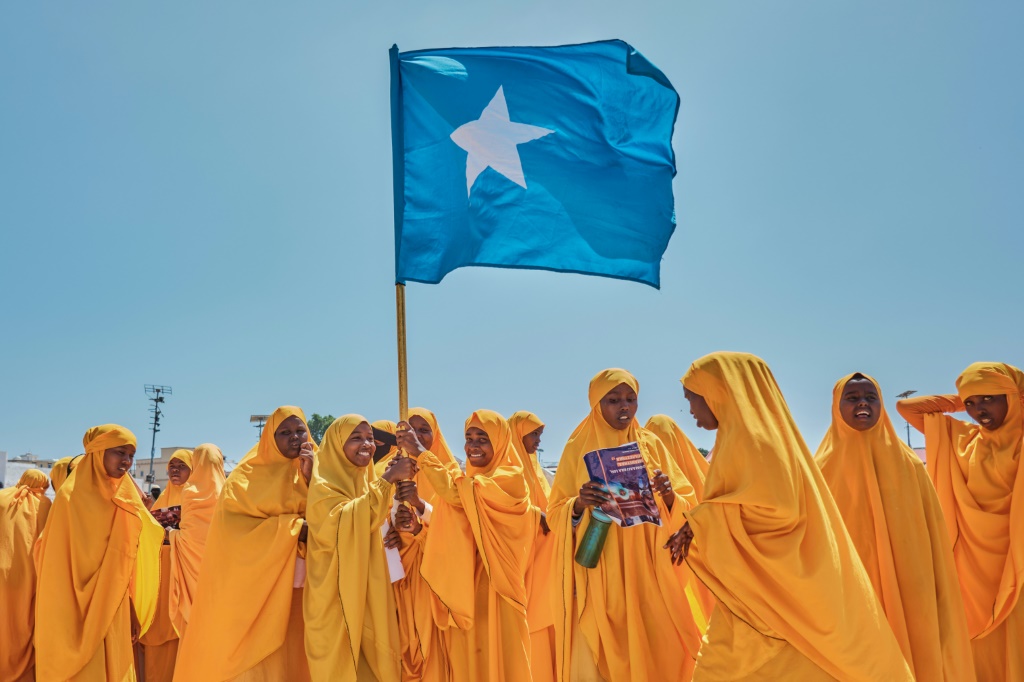 Students wave a Somali flag during a demonstration in support of the government over the controversial deal between Ethiopia and the breakaway region of Somaliland