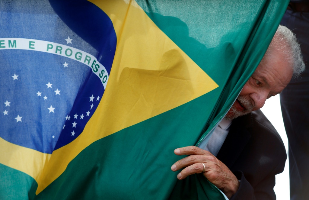 Leftist front-runner Luiz Inacio Lula da Silva has vowed to 'rescue' the flag from 'that fascist' Bolsonaro