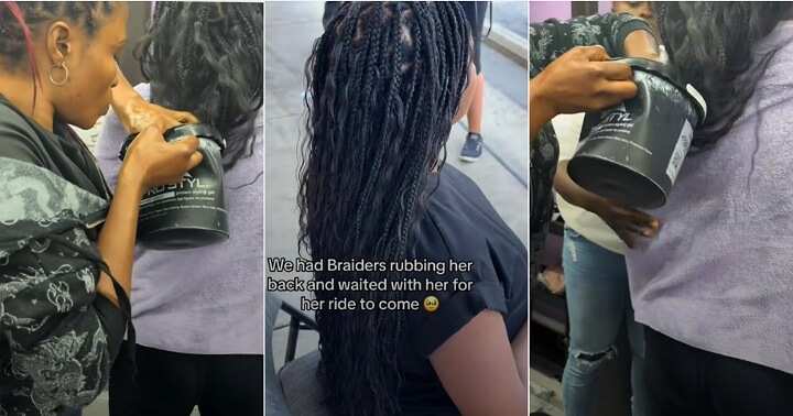 Pregnant woman in labour sits still to braid her hair at a salon