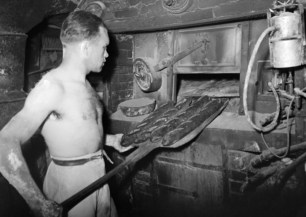 A baker pulls a baguette from the oven in 1947.