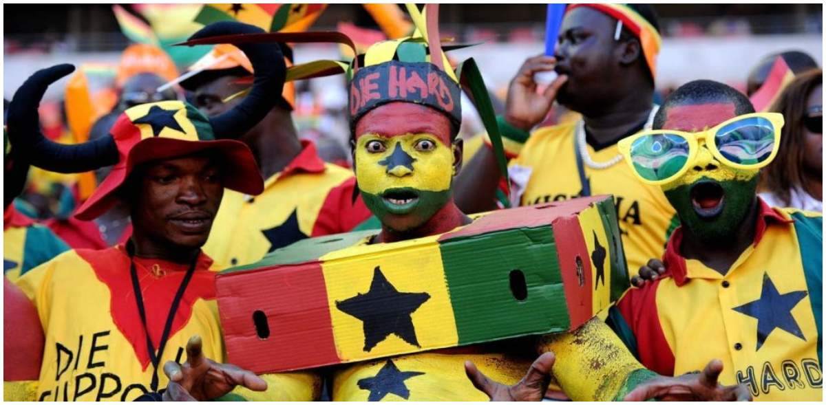 Enthusiastic Ghanaian football supporters cheer the Black Stars on