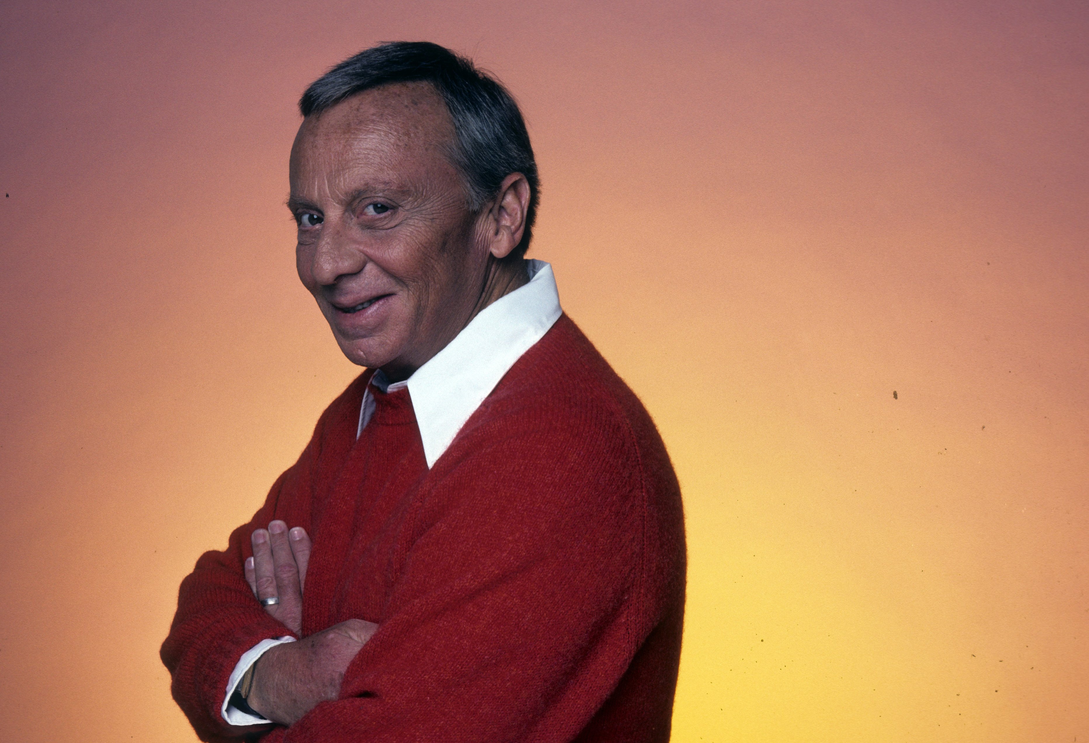 Norman Fell in maroon and white smiles for a photo
