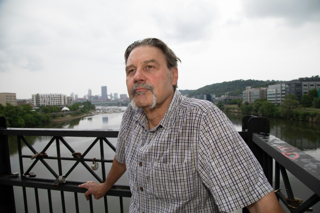 Edward Stankowski, Jr., a former steelworker, stands on the Hot Metal Bridge  above the Monongahela River, a waterway once teeming with iron ore and coal barges for Pittsburgh steel mills