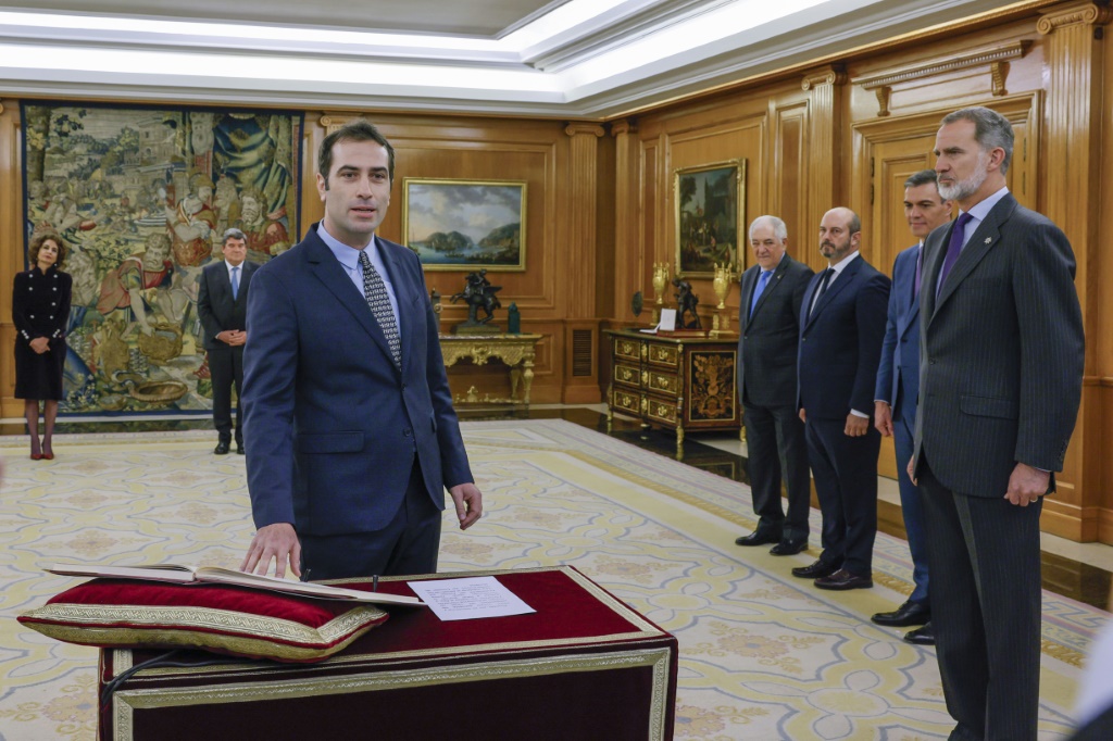 Spain’s new Economy Minister, Carlos Cuerpo, swears on the constitution in front of Spain's King Felipe VI during a ceremony at la Zarzuela Palace in Madrid