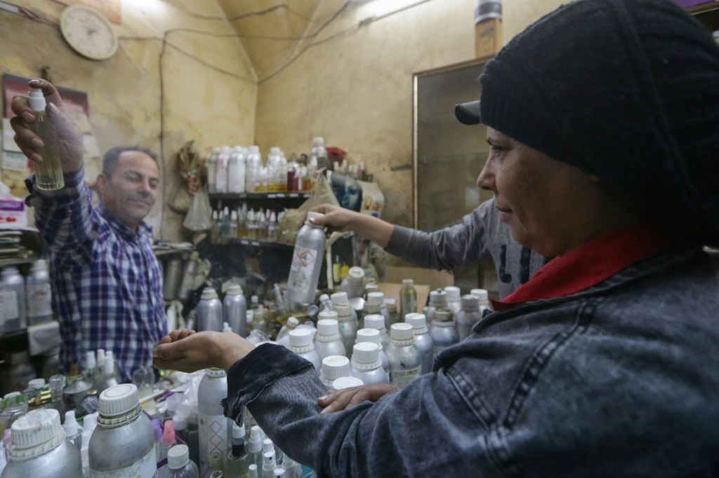 Customers flock to the tiny store in Damascus's old city, many flashing photos of high-end perfumes they want to replicate