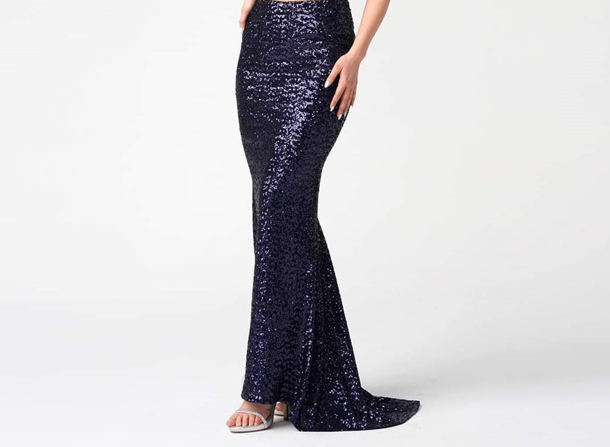 A woman is wearing a glittery mermaid skirt