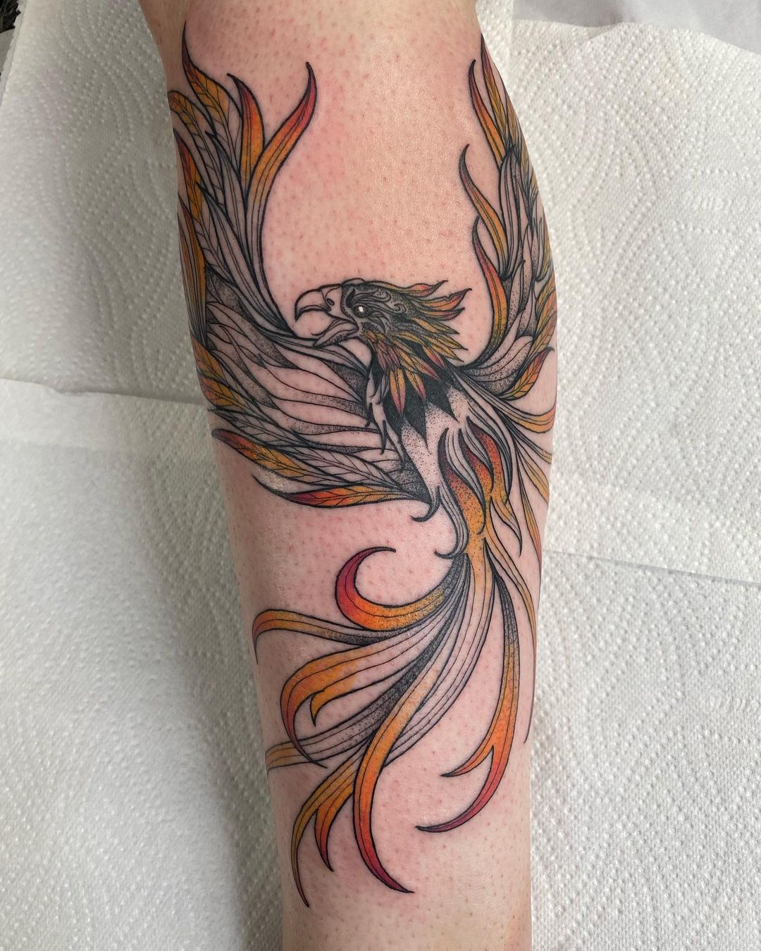 Giant phoenix tattoo appears to rise from the ashes as woman shrugs her  shoulders  and people are mesmerised  The Sun