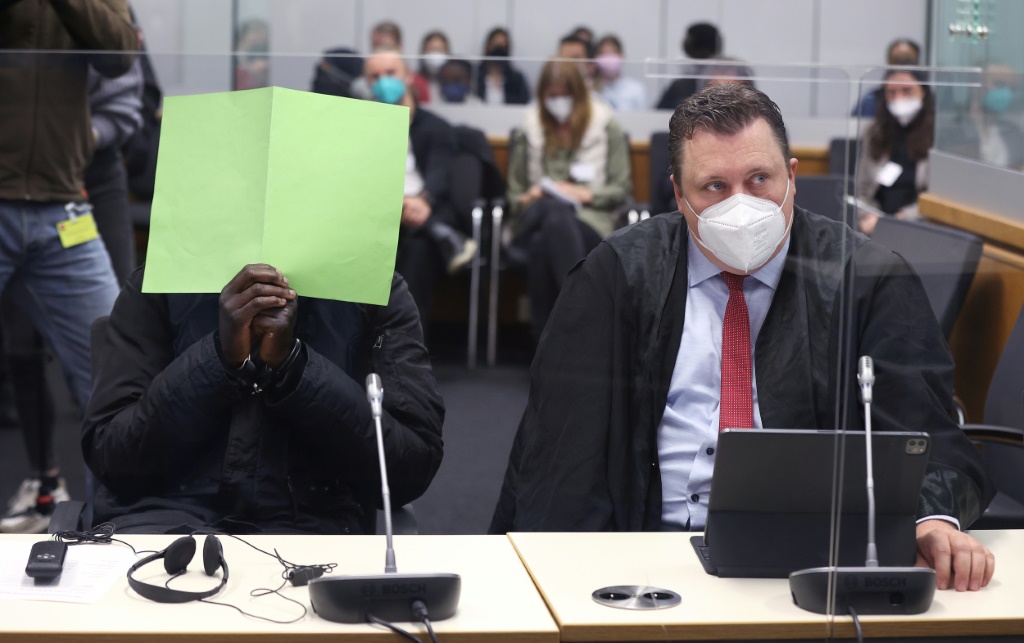 Lowe, pictured with his face covered at the opening of his trial in Celle on April 25